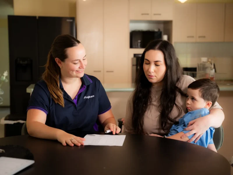Adult women with young boy talking with womens homelessness worker