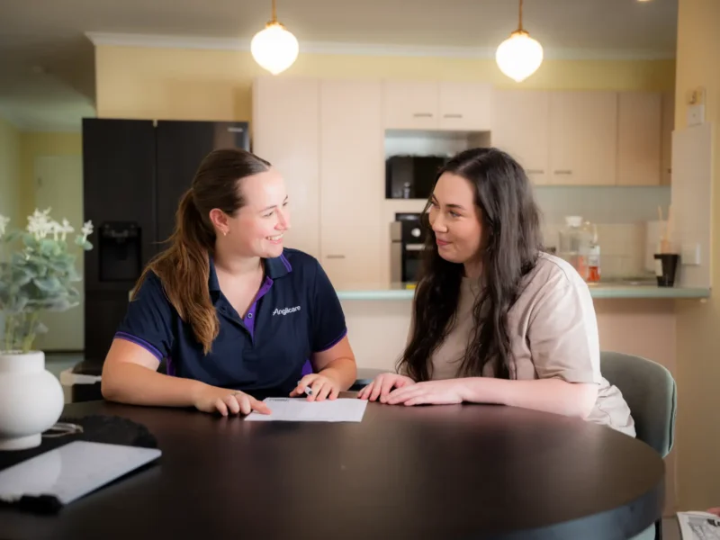 Womens homelessness worker supporting client with paperwork