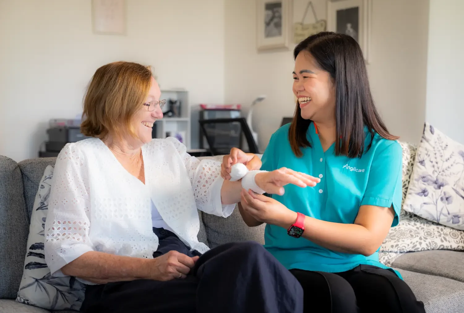 personal care and hygiene worker helping bandage wound.