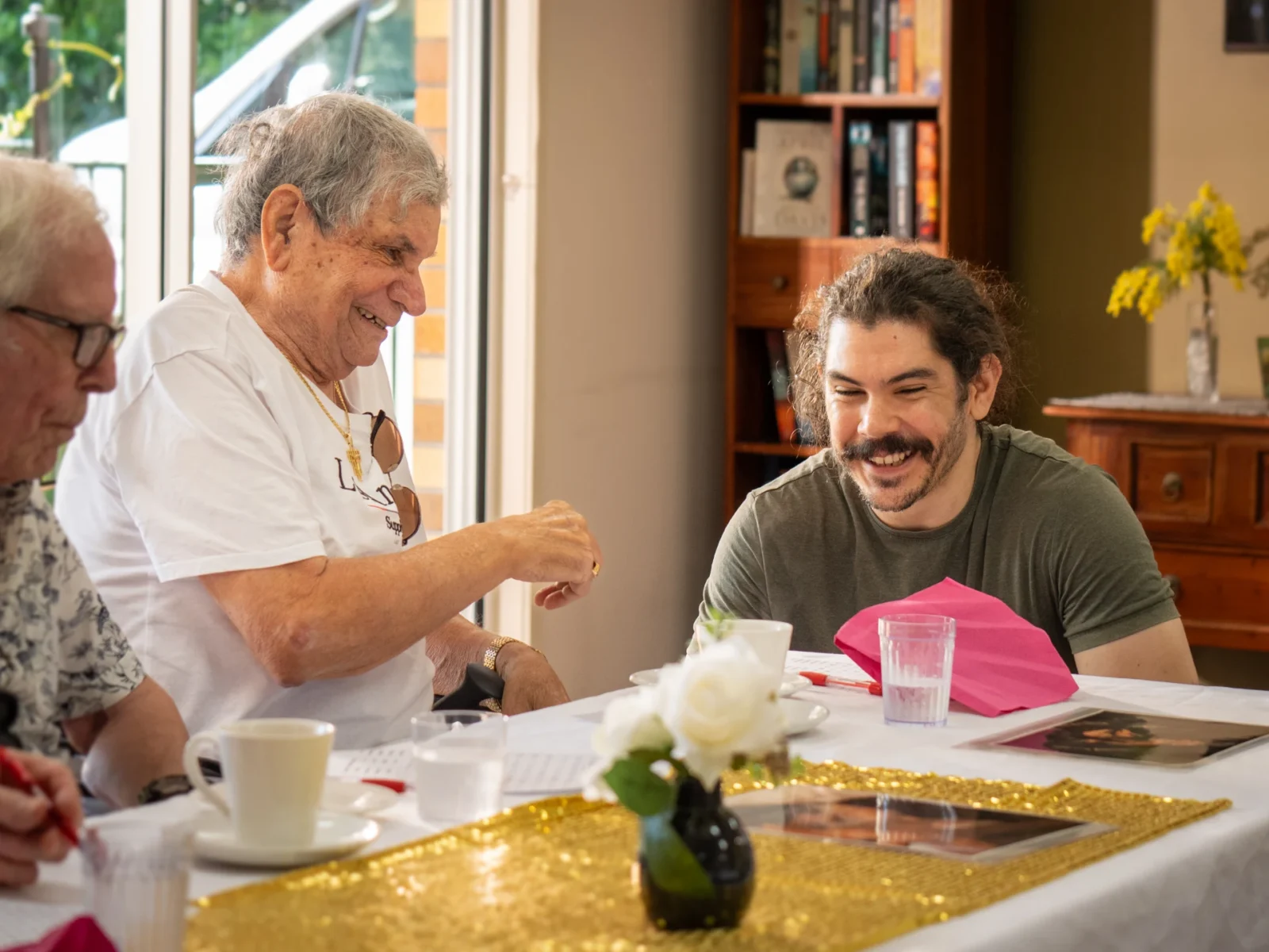 Young male volunteer spending time with male residents.