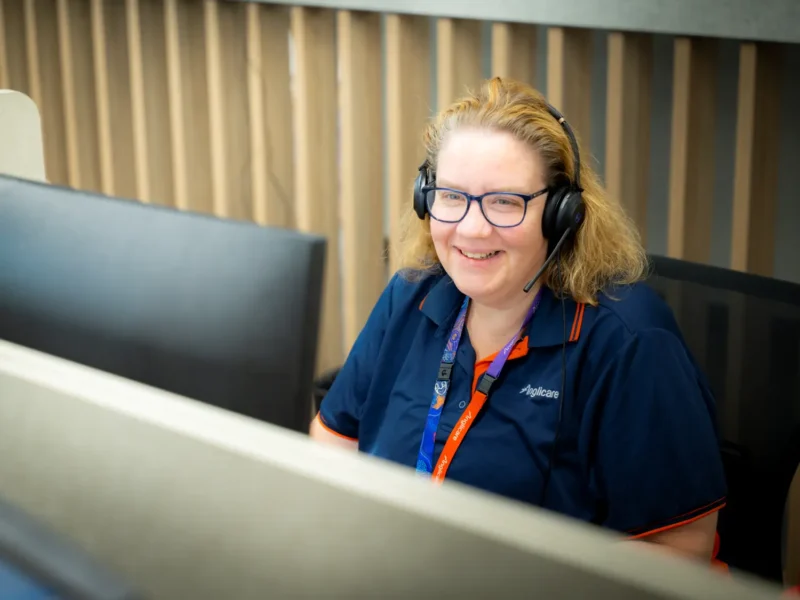 Anglicare staff member speaking on the phone with client