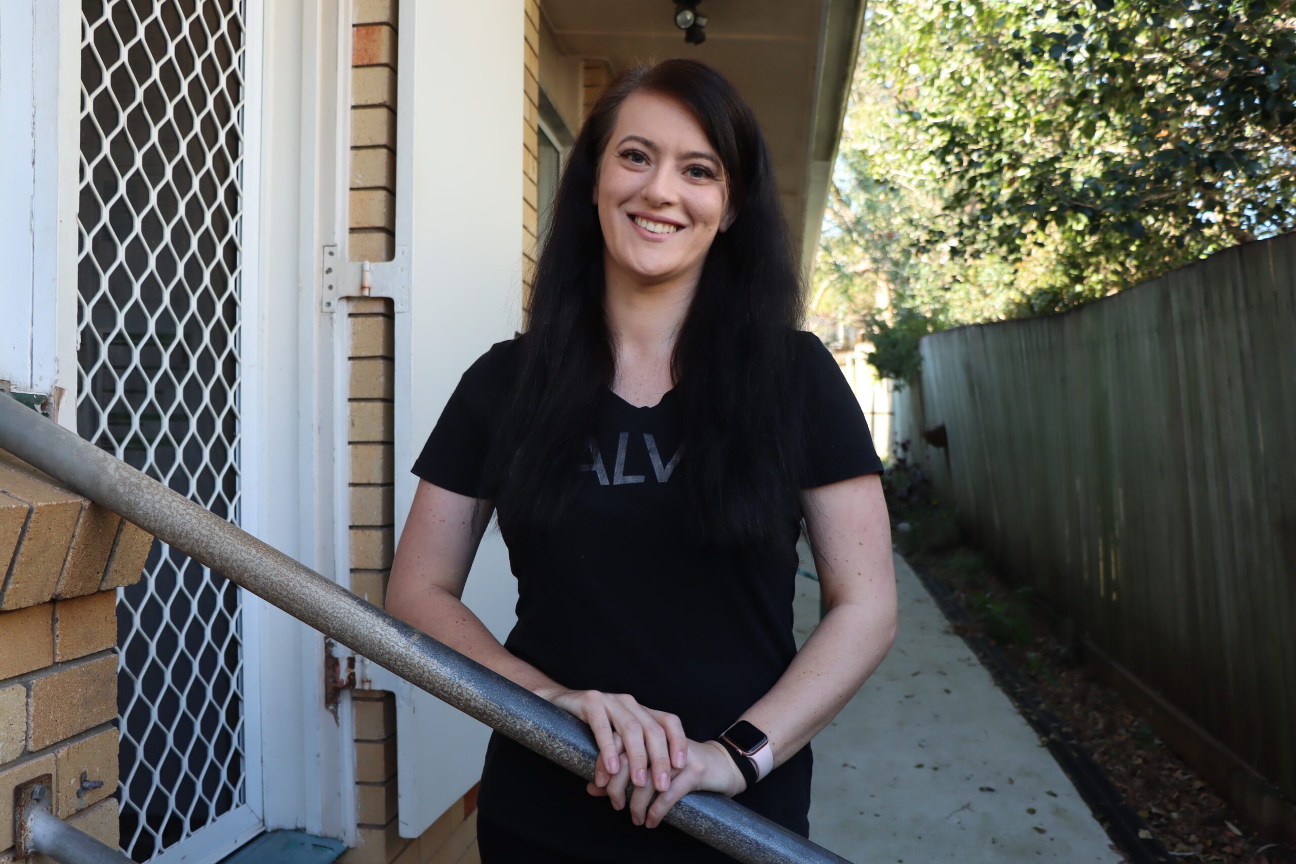 Pictured: Cherice, former youth homelessness client standing outside of Nathaniel House crisis accommodation.