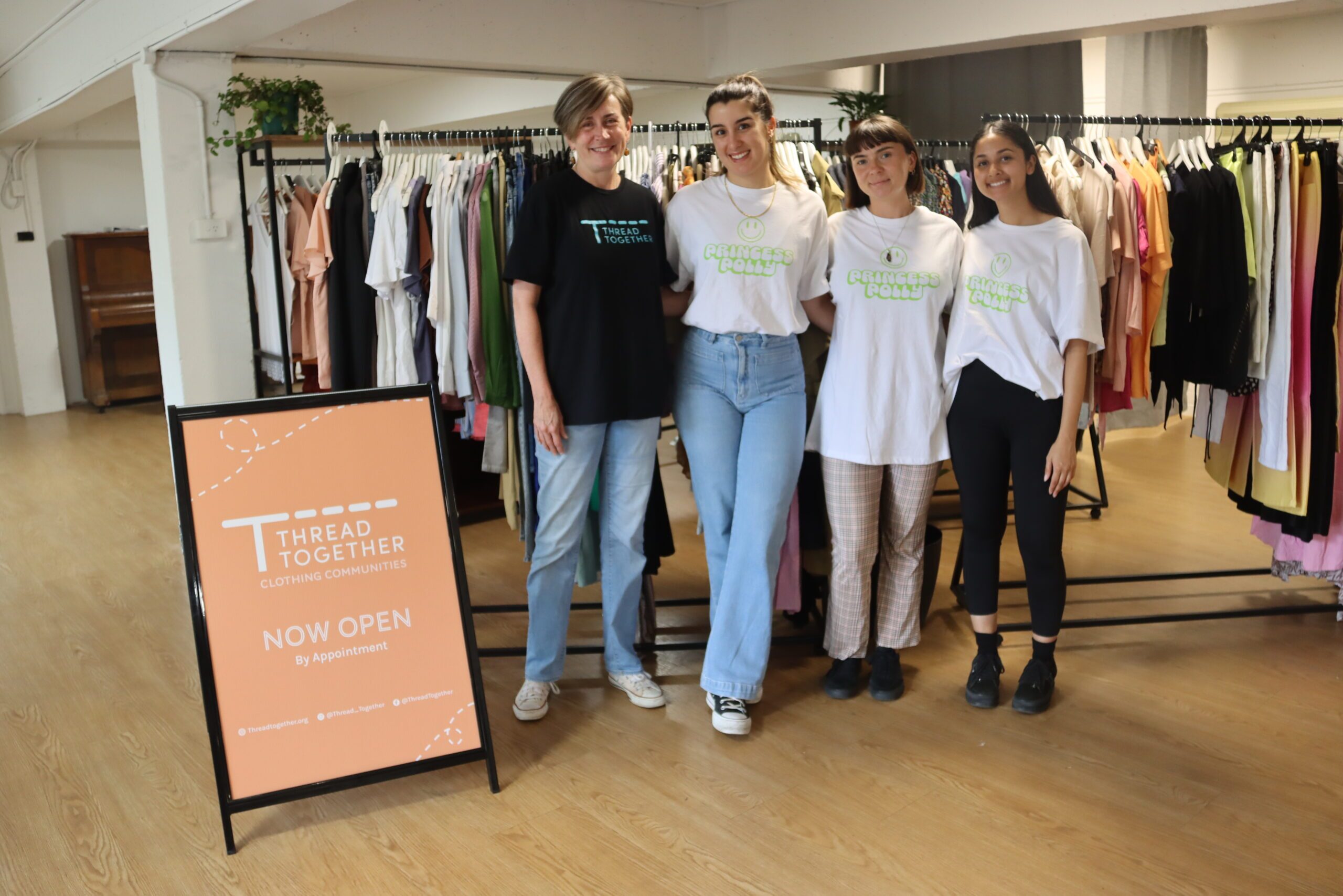 Thread Together volunteers posing in the clothing hub
