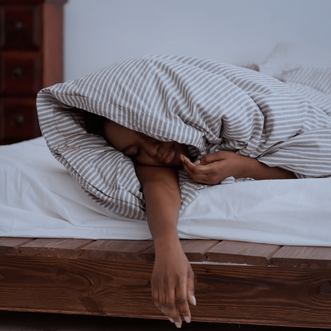 Person sleeping in bed to improve their health and wellbeing