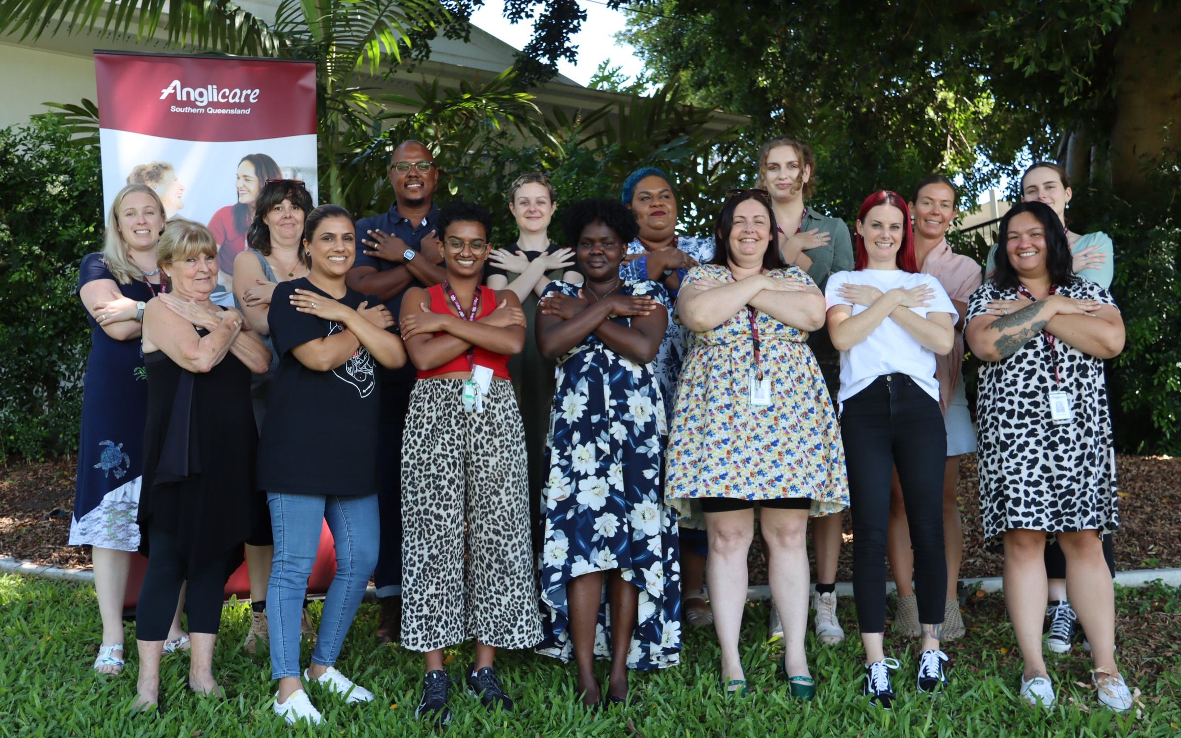 Staff from Anglicare's women's homelessness service posing in an embrace