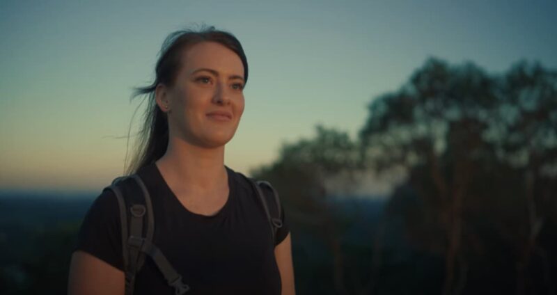 Cherice, smiling while looking out to a sunset