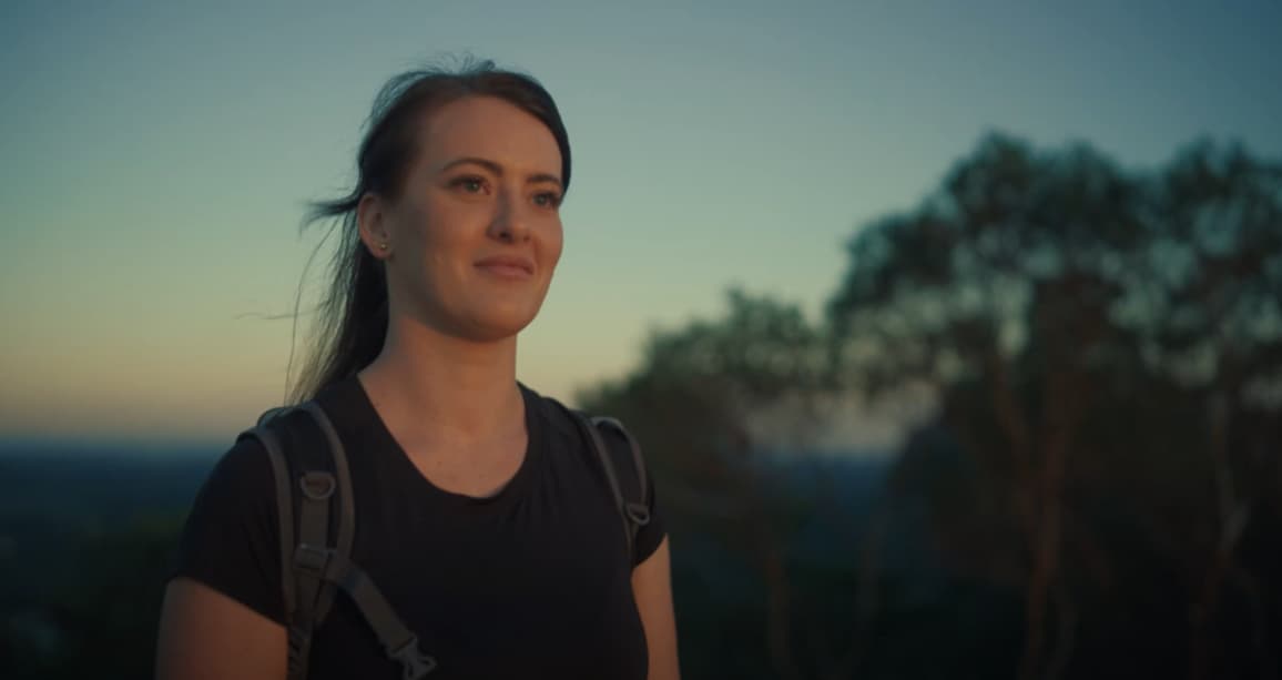 Cherice, smiling while looking out to a sunset