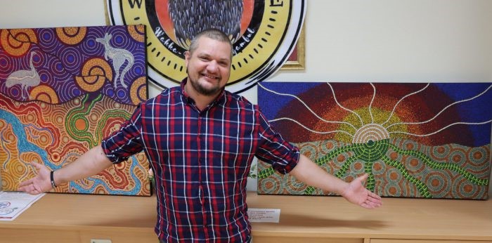 First Nations artist, Kye Lane-Hart with his painting