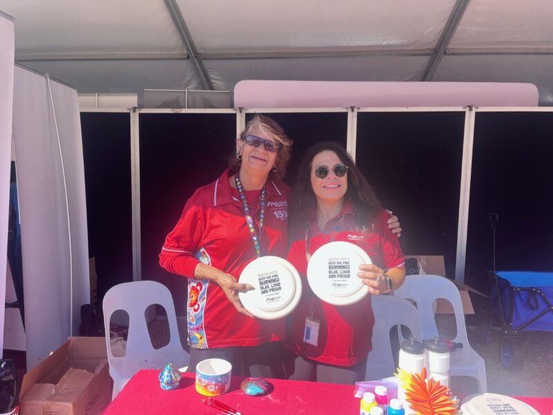 Two staff posed for a Logan NAIDOC Week event