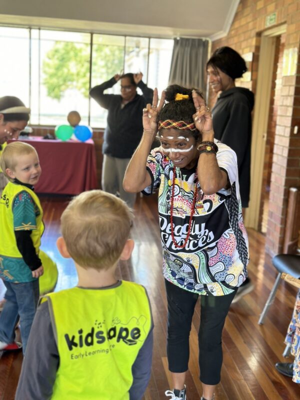 Staff and children dancing at a family NAIDOC week event in Caboolture