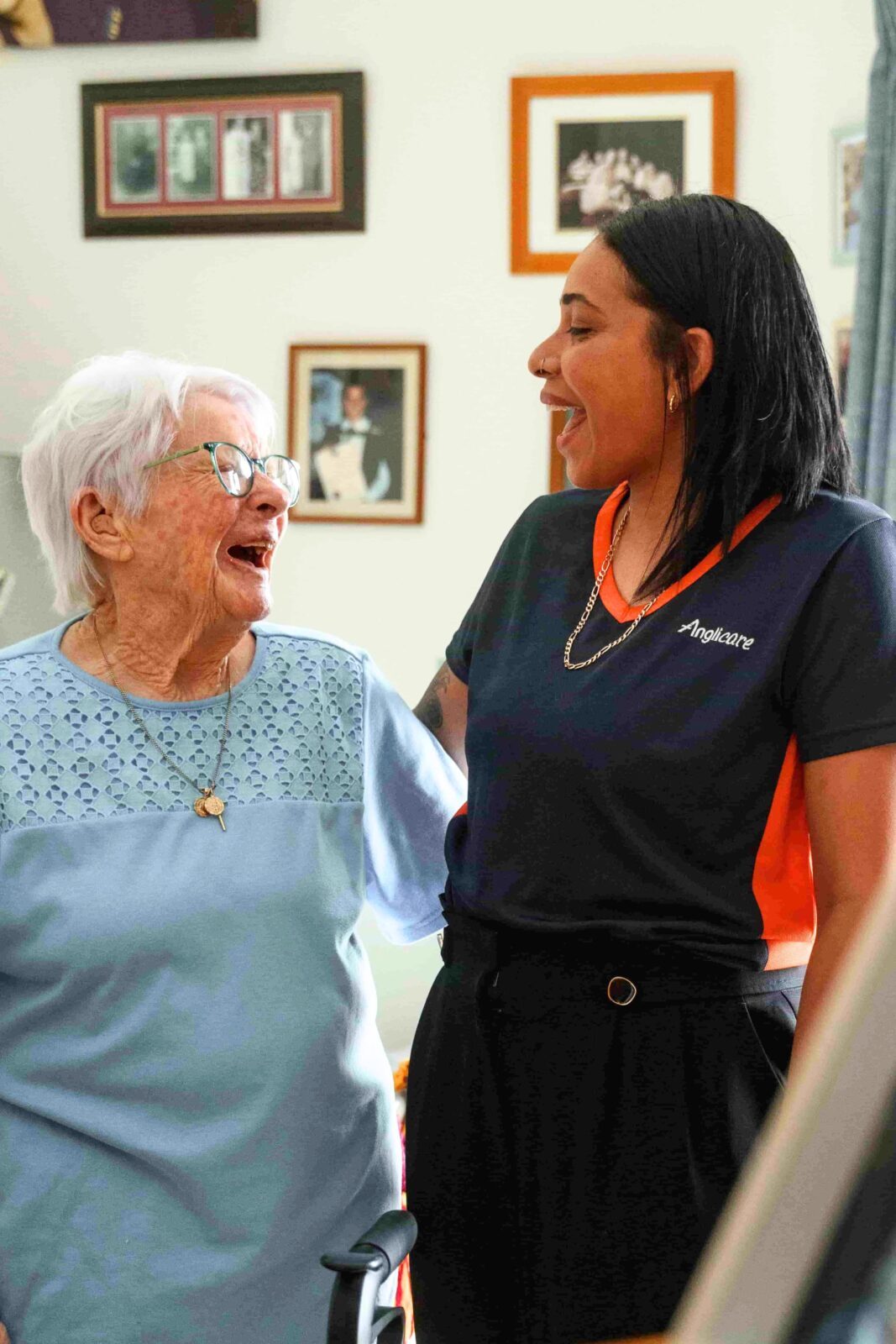 Anglicare emplyee and resident smiling at each other