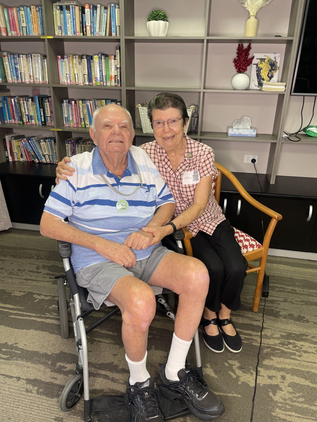 Lorraine and Dennis sitting next to each other smiling