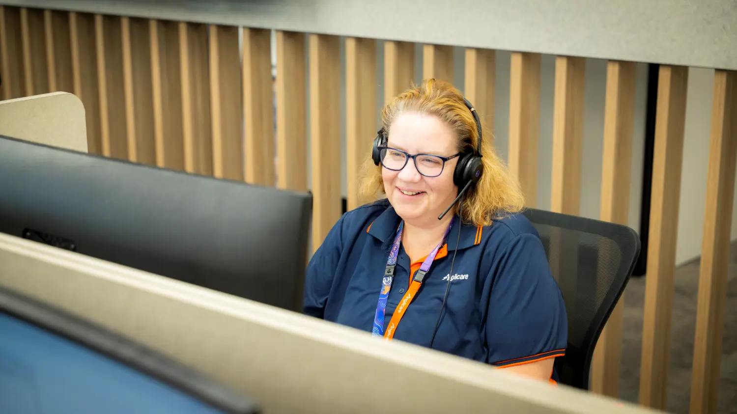 Anglicare worker on phone to client