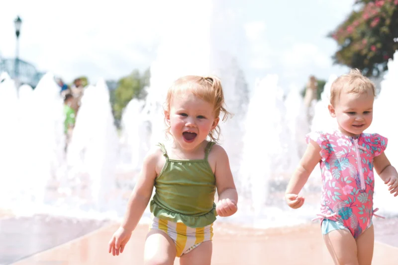 Toddler running though water park.