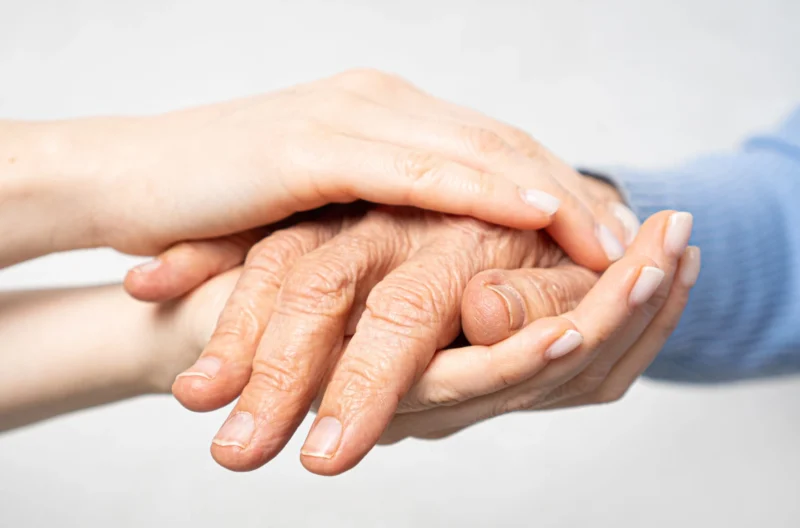 Young hands holding old hands.