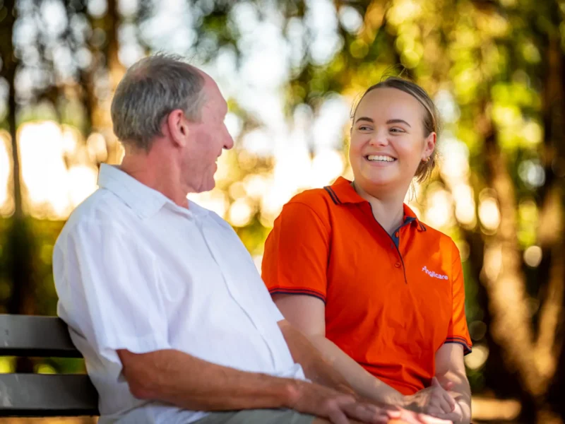 Anglicare Southern Queensland worker talking to elderly male on an outing.