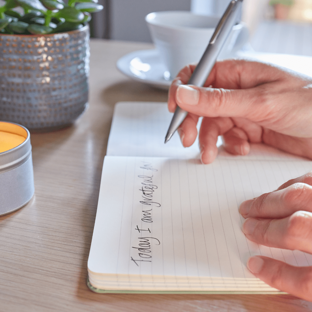Person writing things they are grateful for. A good way to improve mental wellbeing.