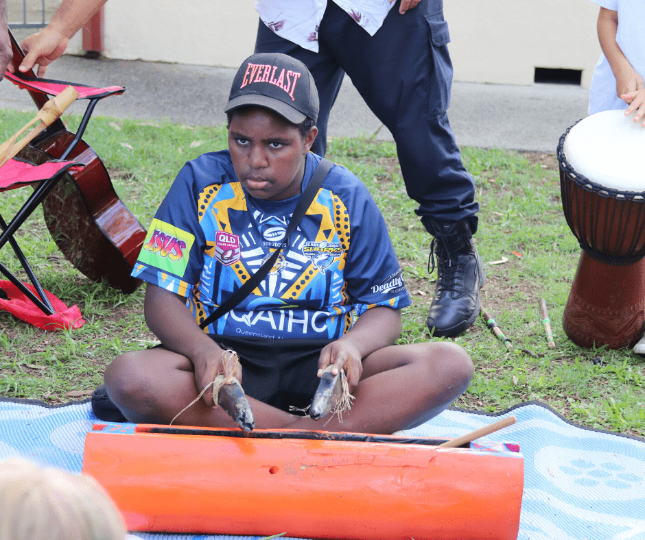 Young First Nations boy playing instrument for Jarjums event