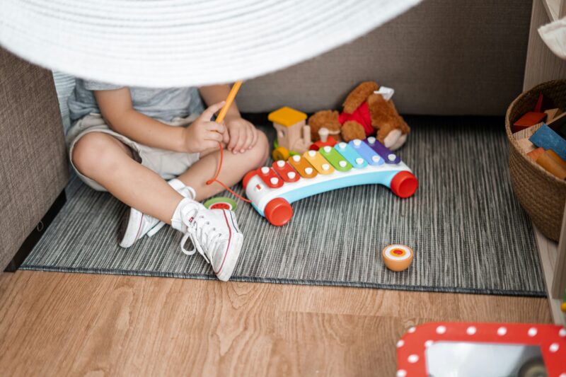 Child playing under a fort