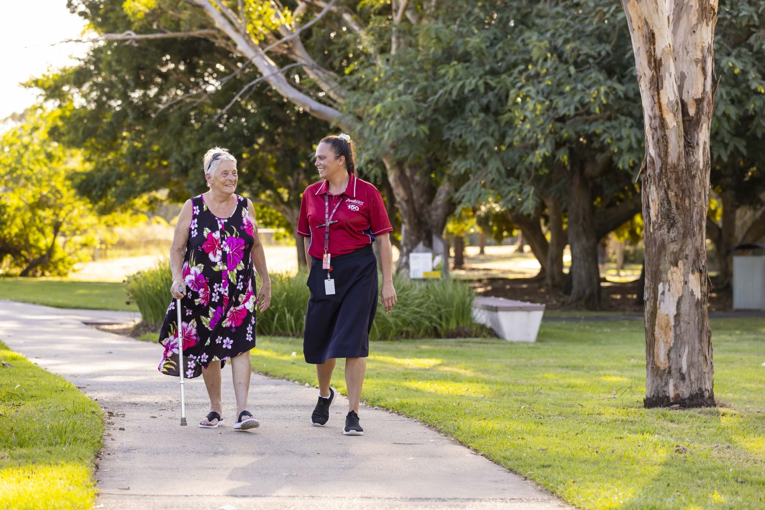 Support at Home staff member walking with client outside