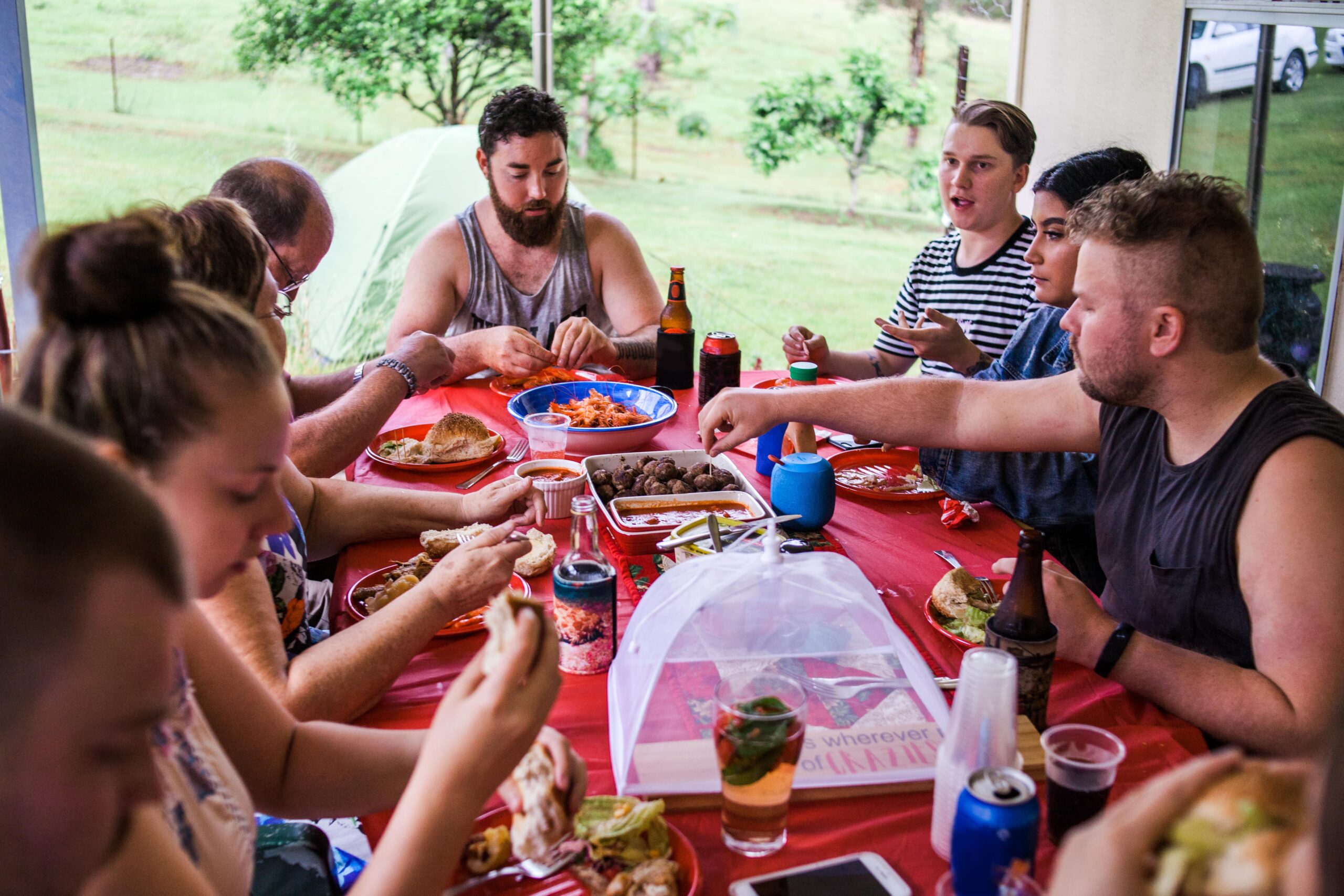 Family time: a family of eight adults sitting on a patio having lunch