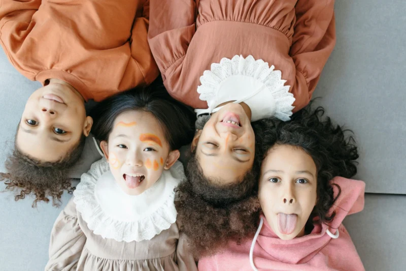 Children smiling together while building resilience through friendship and play