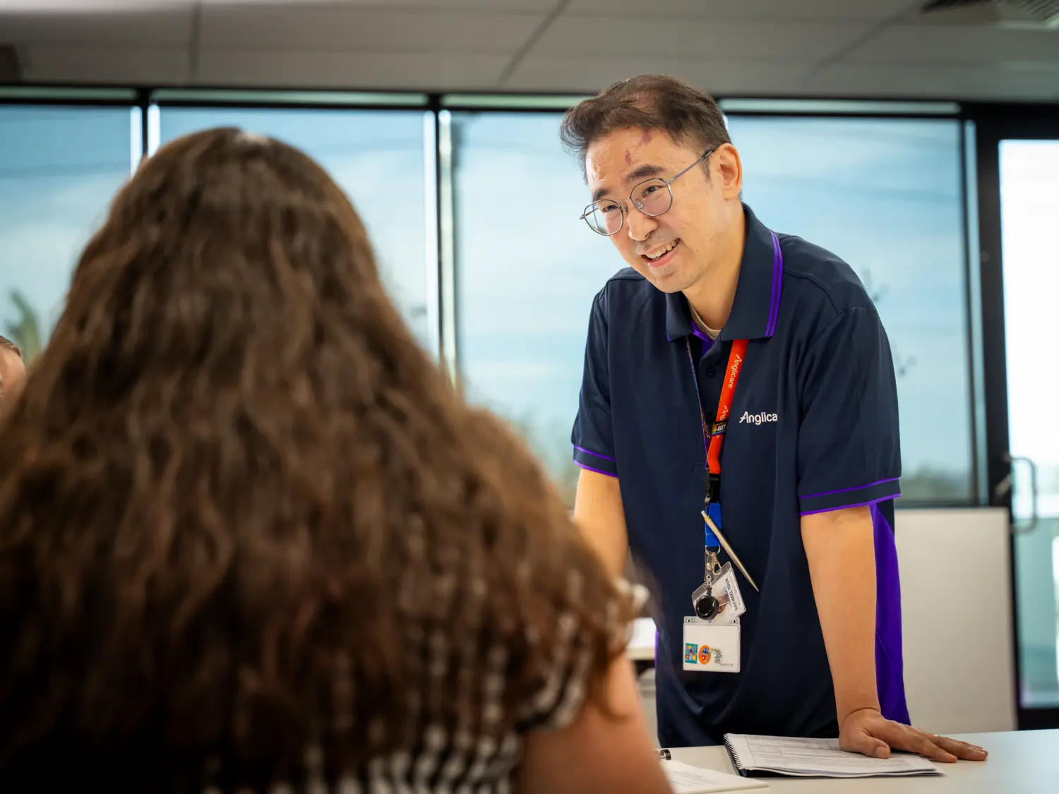 Anglicare worker with research and advocacy student