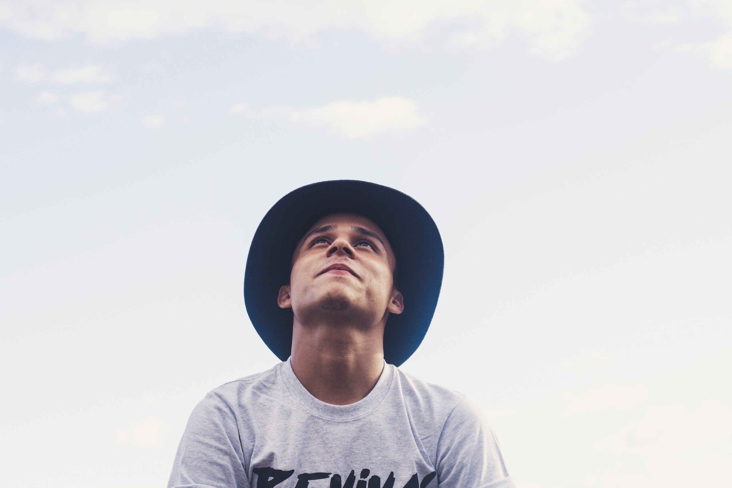 Alan's story: Teenager with hat looking up to sky