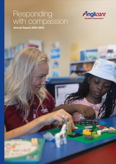 Anglicare Southern Queensland staff member helping young girl play.