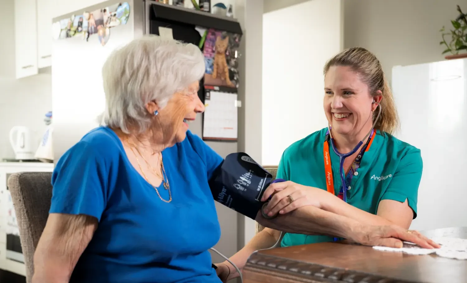 Anglicare staff member taking blood pressure of client