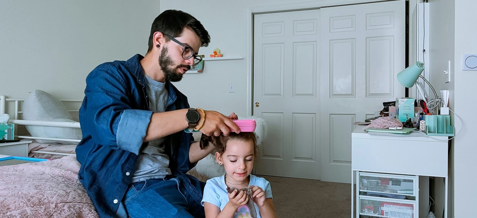 Father brushing daughters hair
