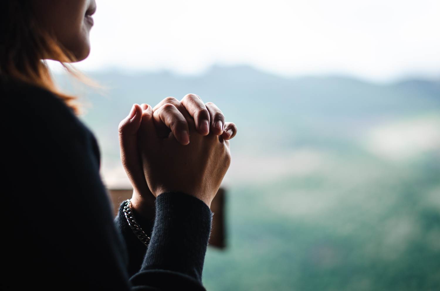 Woman praying to God for Anglicare Southern Queensland