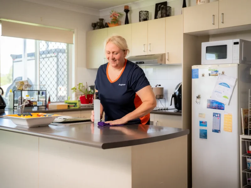 Home Care Worker cleaning kitchen for client