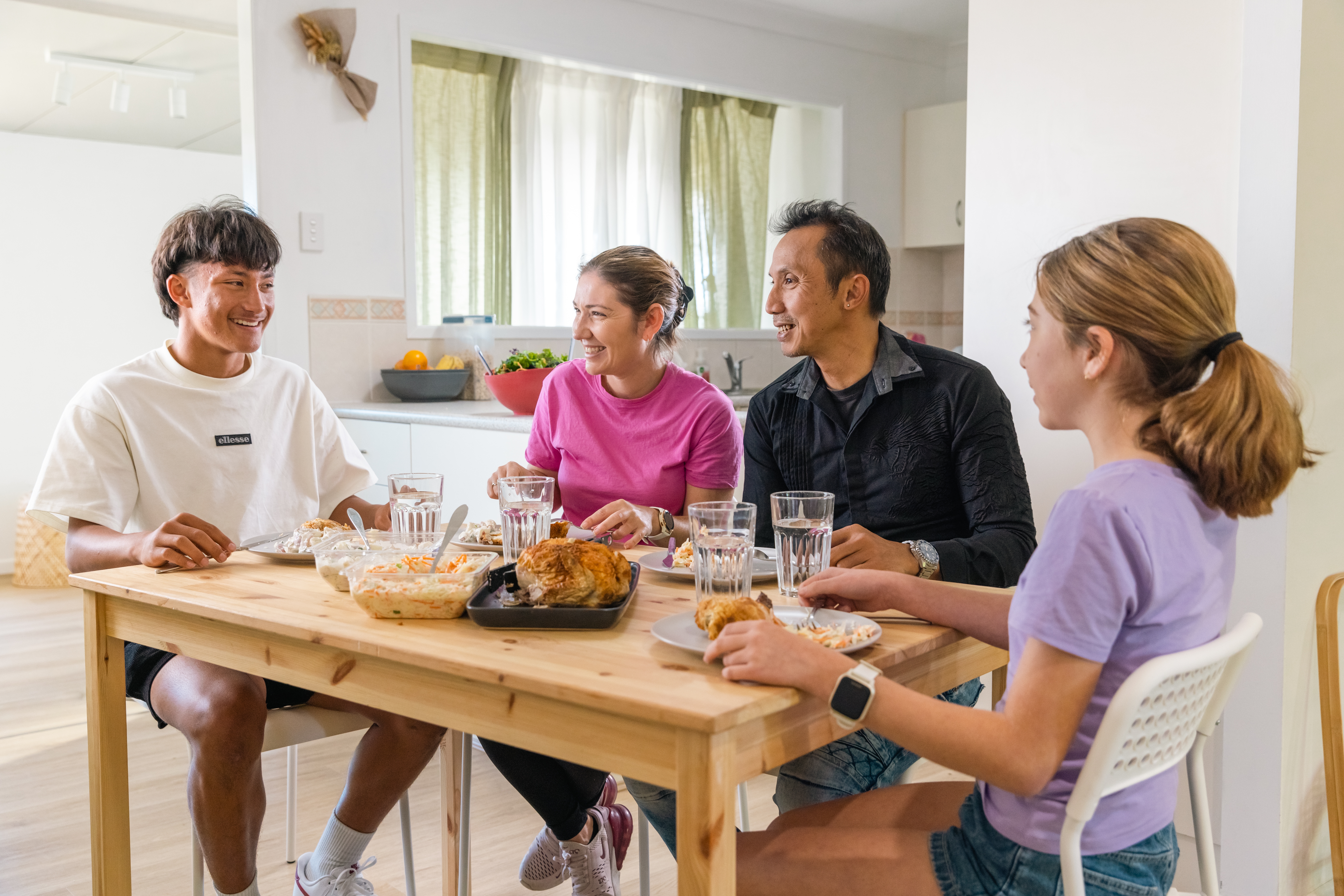 Blended families sitting together eating lunch at the table