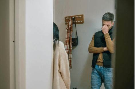 Couple having a disagreement in hallway of home
