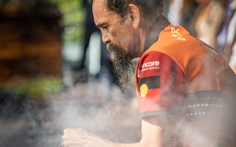 First Nations man doing a smoking ceremony.