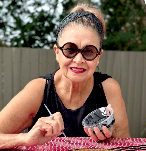 Aunty Denise Proud sitting outside and painting
