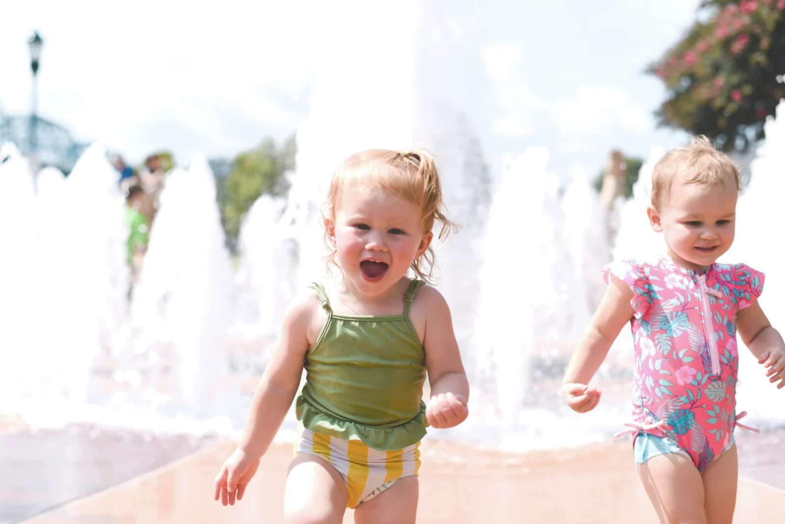 Toddler running though water park.