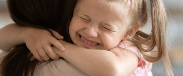 Mark and Jenny's story.
Foster mother hugging girl.