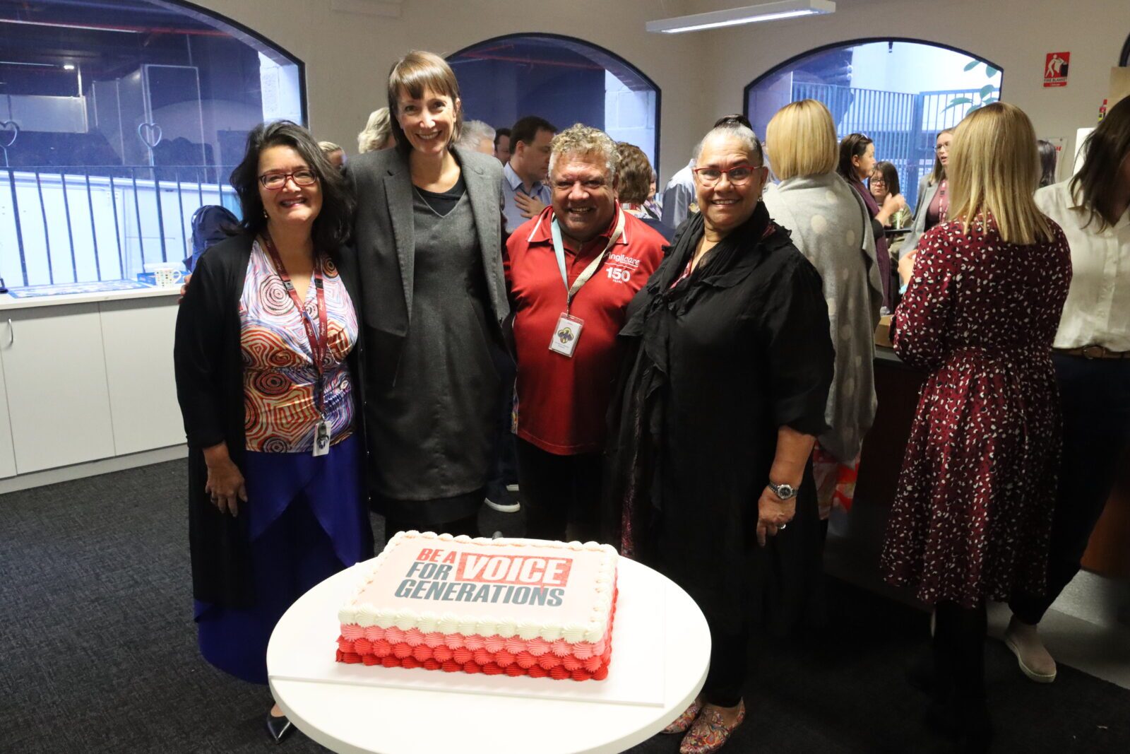 Picture of Anglicare staff pictured around a themed cake for Reconciliation Week in 2023