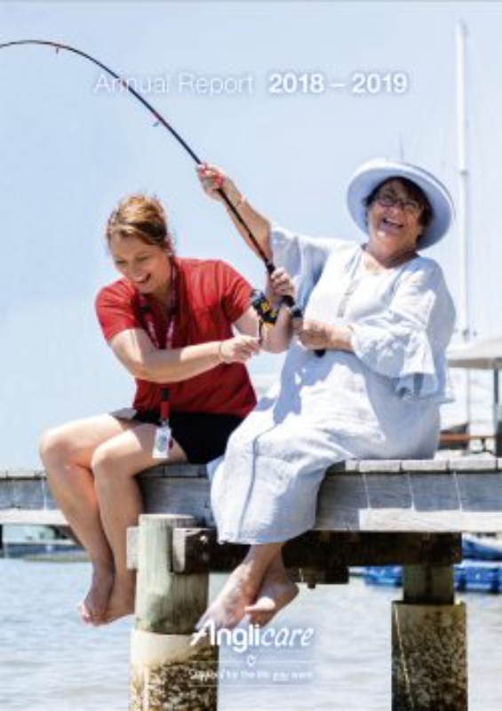 Two women sit on a jetty by the water, smiling and fishing together. One wears a red shirt, the other a white dress and hat. Text reads Annual Report 2018–2019 and Anglicare, highlighting stories found in our annual reports.