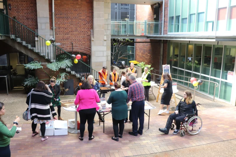 group of people in a courtyard setting up a fundraising event